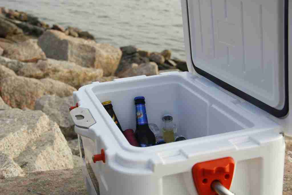 open cooler with beer on a beach