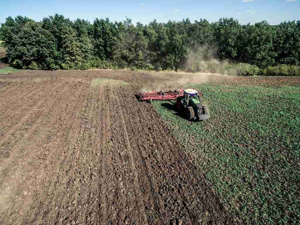 aerial photo/ top view of a tractor plowing a field to plant food plot seeds for deer
