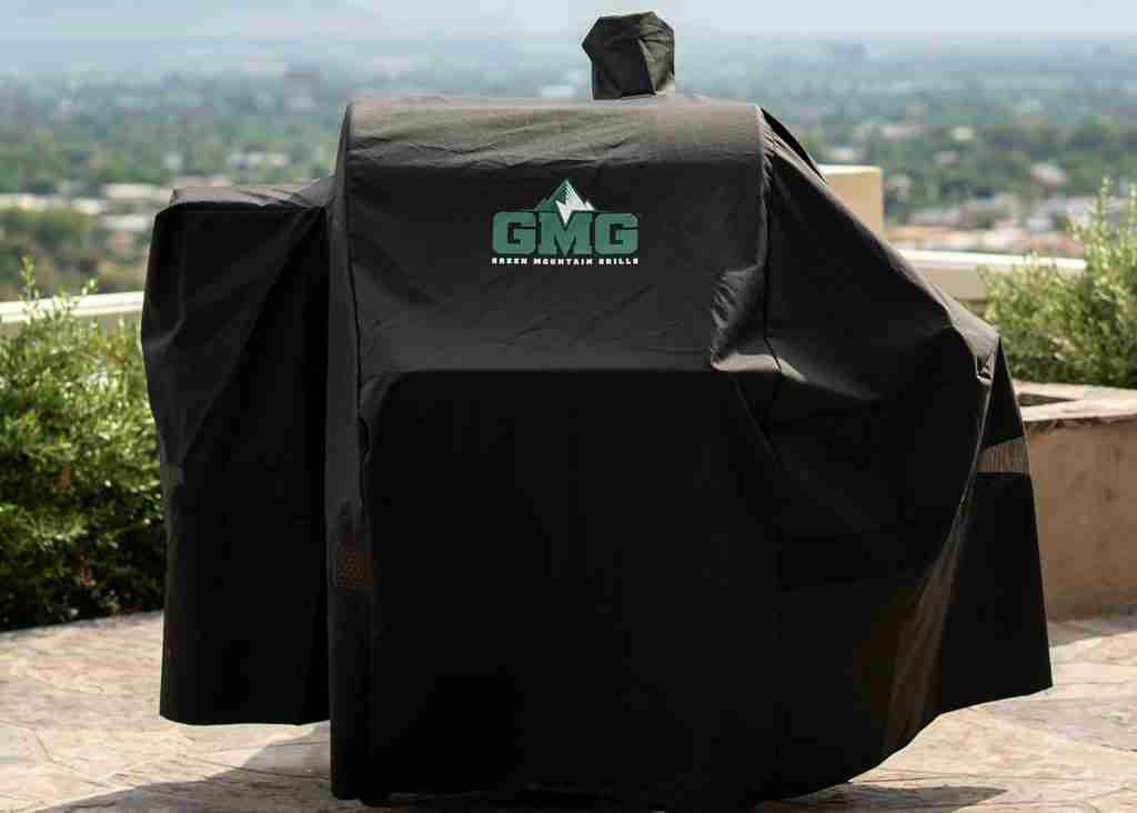 Green Mountain Grills pellet grill cover draped over a pellet grill on top of a beautiful outdoor balcony. 