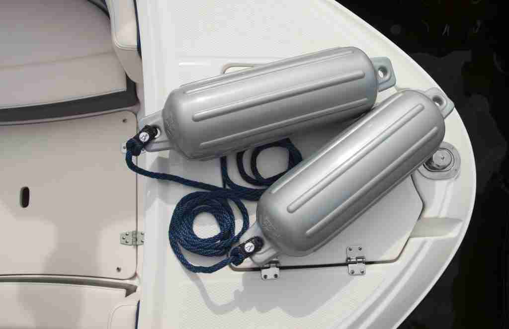 Silver boat fenders on top of a boat on the water.