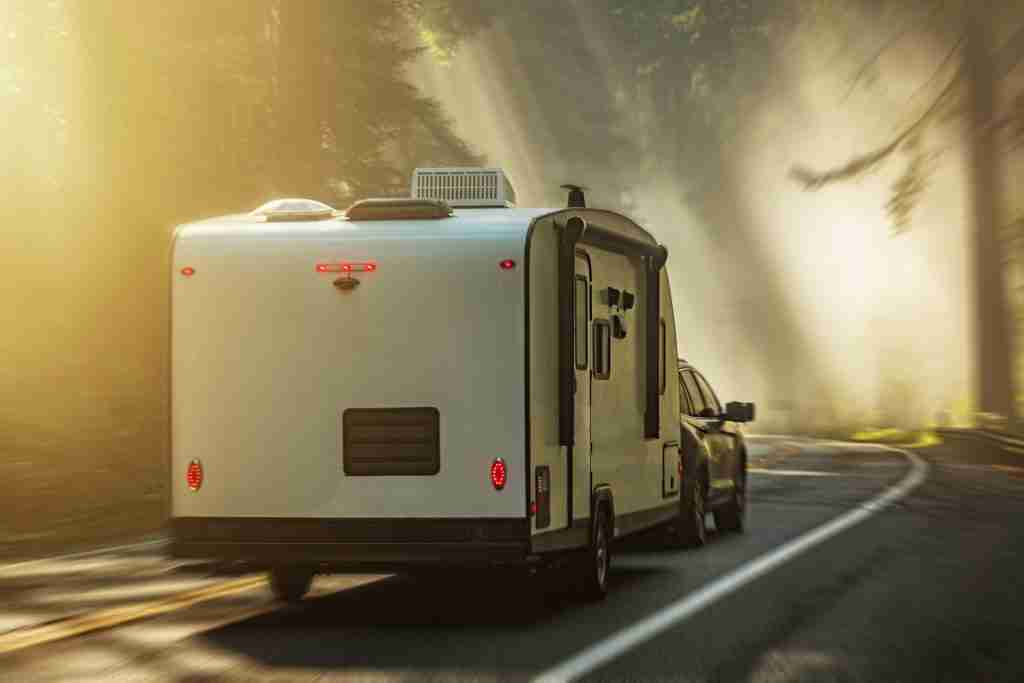 Modern Travel Trailer RV Scenic Route Road Trip Travel Through Foggy Redwood Forests of Northern California, United States of America.