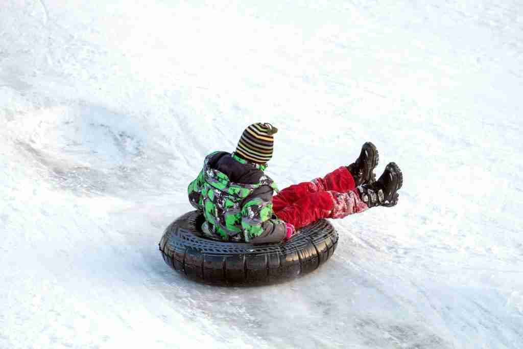 Kid on snow tube